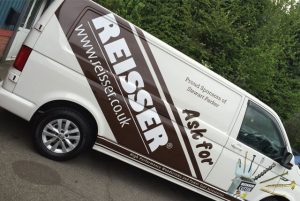 A picture of a Reisser van with the company's vehicle wrap